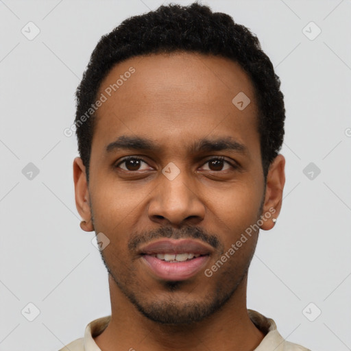 Joyful black young-adult male with short  black hair and brown eyes