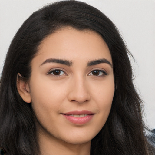 Joyful latino young-adult female with long  brown hair and brown eyes