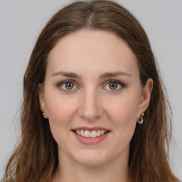 Joyful white young-adult female with long  brown hair and grey eyes