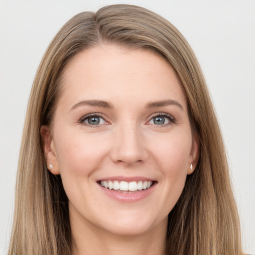 Joyful white young-adult female with long  brown hair and blue eyes