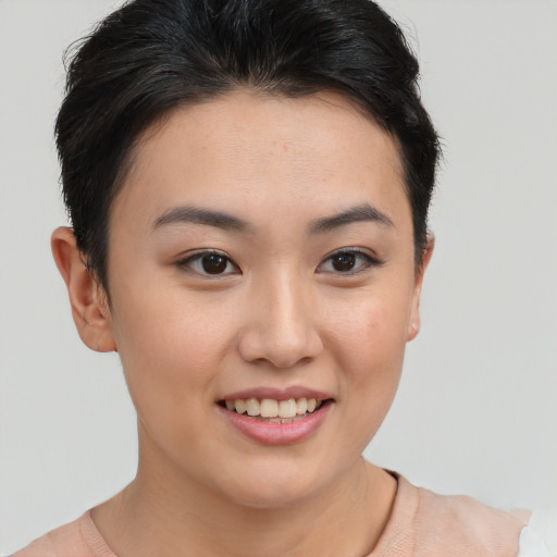 Joyful asian young-adult female with short  brown hair and brown eyes