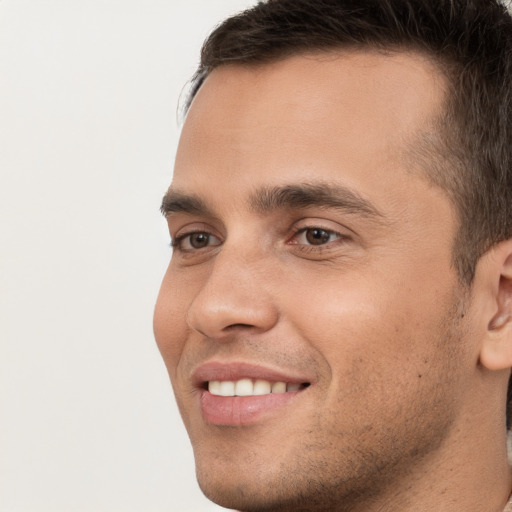 Joyful white young-adult male with short  brown hair and brown eyes