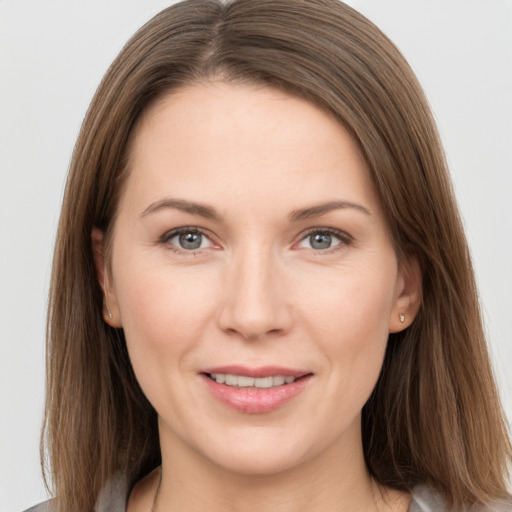 Joyful white young-adult female with long  brown hair and grey eyes