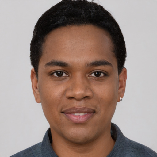 Joyful black young-adult male with short  black hair and brown eyes