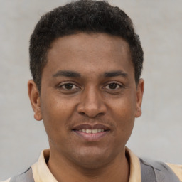 Joyful latino young-adult male with short  brown hair and brown eyes