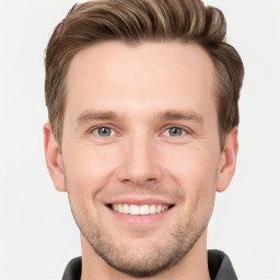 Joyful white young-adult male with short  brown hair and grey eyes