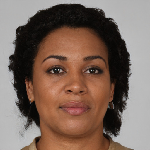 Joyful black adult female with short  brown hair and brown eyes