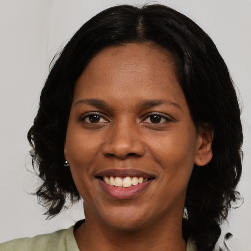 Joyful black young-adult female with medium  brown hair and brown eyes