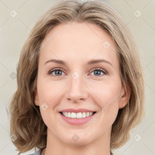 Joyful white young-adult female with medium  brown hair and green eyes