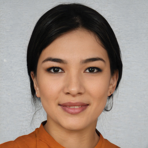 Joyful white young-adult female with medium  black hair and brown eyes