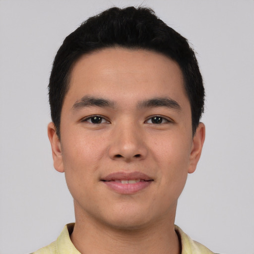Joyful asian young-adult male with short  black hair and brown eyes