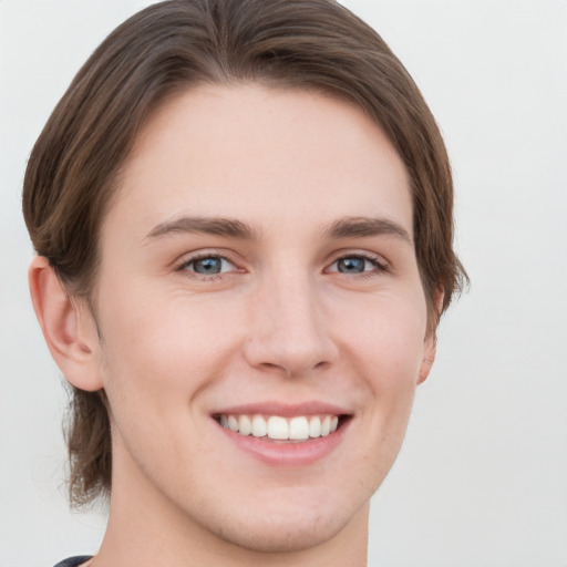 Joyful white young-adult female with short  brown hair and grey eyes