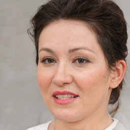 Joyful white adult female with medium  brown hair and brown eyes