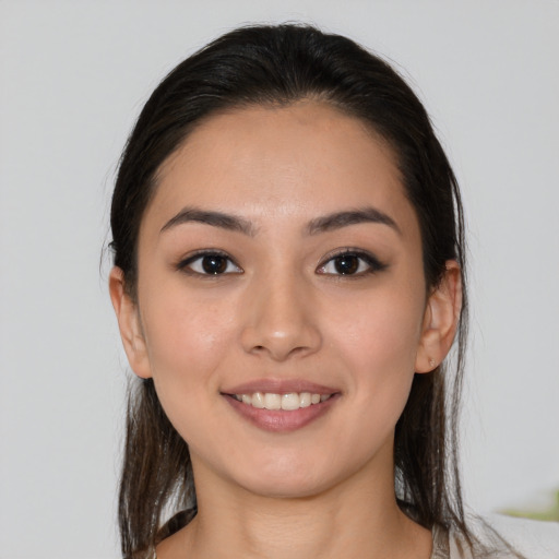 Joyful white young-adult female with medium  brown hair and brown eyes