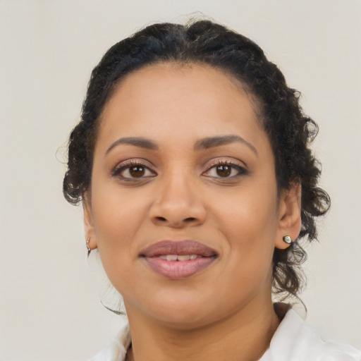 Joyful black young-adult female with medium  brown hair and brown eyes