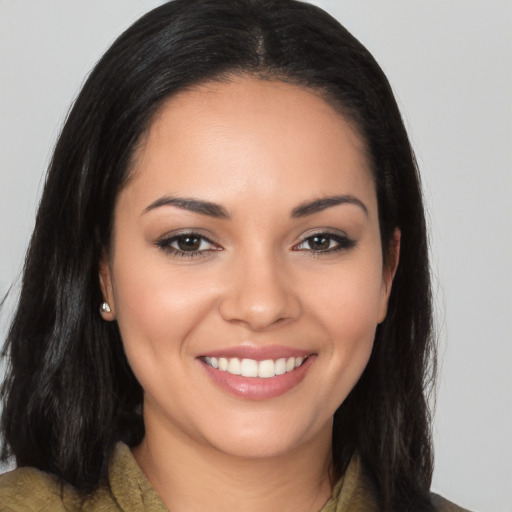 Joyful latino young-adult female with long  brown hair and brown eyes