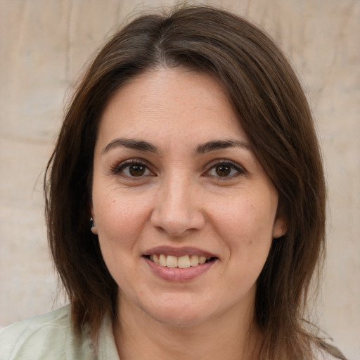 Joyful white adult female with medium  brown hair and brown eyes