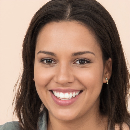 Joyful white young-adult female with long  brown hair and brown eyes