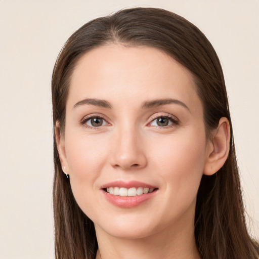 Joyful white young-adult female with long  brown hair and brown eyes