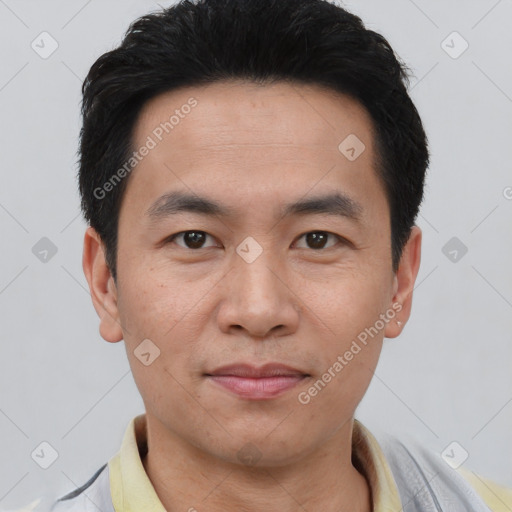 Joyful asian young-adult male with short  brown hair and brown eyes