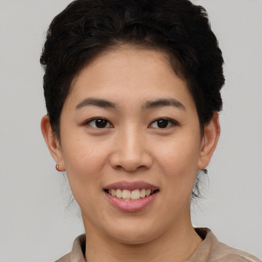 Joyful asian young-adult female with short  brown hair and brown eyes