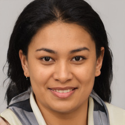 Joyful latino young-adult female with medium  brown hair and brown eyes