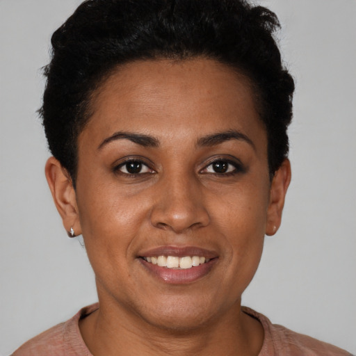 Joyful black young-adult female with short  brown hair and brown eyes