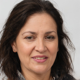 Joyful white adult female with long  brown hair and brown eyes