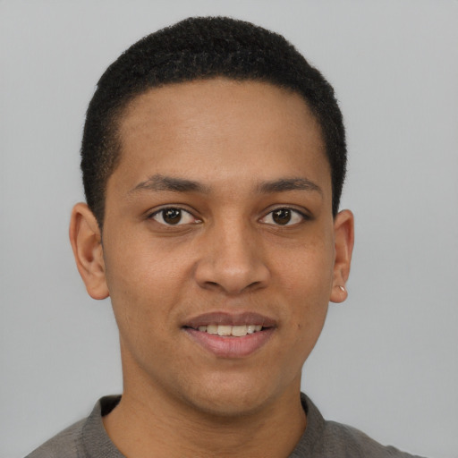 Joyful black young-adult male with short  brown hair and brown eyes