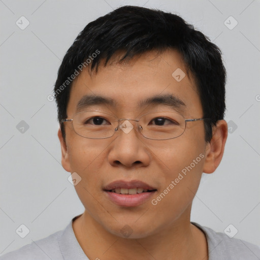 Joyful asian young-adult male with short  black hair and brown eyes