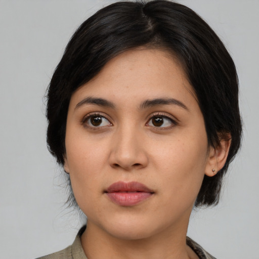 Joyful latino young-adult female with medium  black hair and brown eyes