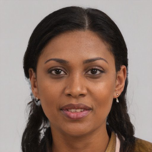 Joyful black young-adult female with long  black hair and brown eyes