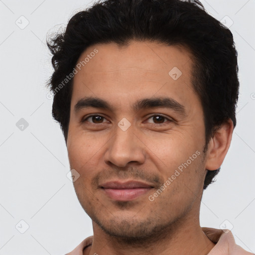 Joyful latino young-adult male with short  black hair and brown eyes