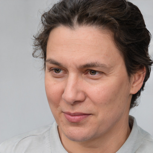 Joyful white adult male with medium  brown hair and brown eyes