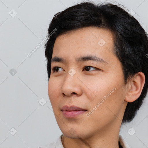Joyful asian young-adult male with short  black hair and brown eyes