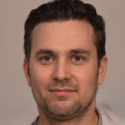 Joyful white adult male with short  brown hair and brown eyes