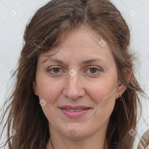 Joyful white adult female with long  brown hair and brown eyes