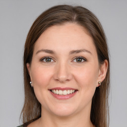 Joyful white young-adult female with medium  brown hair and grey eyes