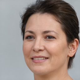 Joyful white adult female with medium  brown hair and brown eyes