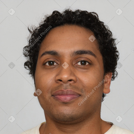 Joyful black young-adult male with short  brown hair and brown eyes