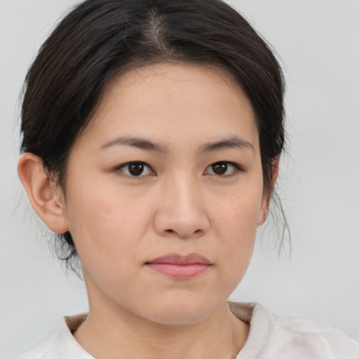 Joyful asian young-adult female with medium  brown hair and brown eyes
