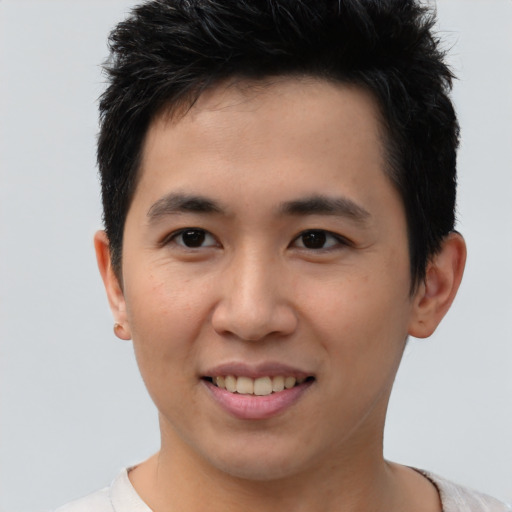 Joyful asian young-adult male with short  brown hair and brown eyes