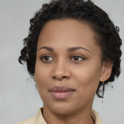 Joyful black adult female with medium  brown hair and brown eyes