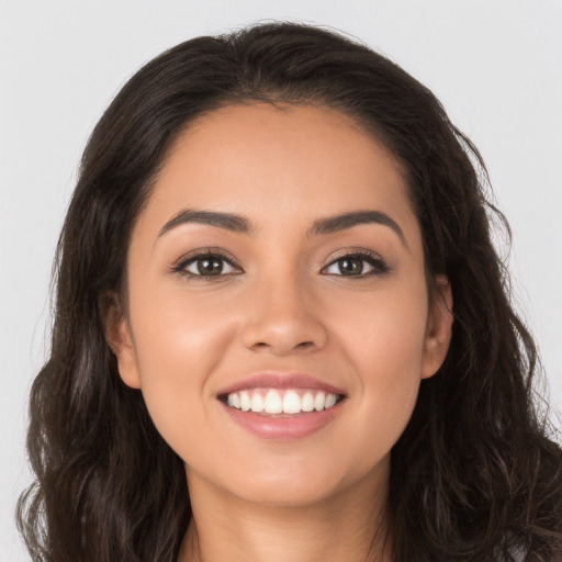 Joyful white young-adult female with long  brown hair and brown eyes