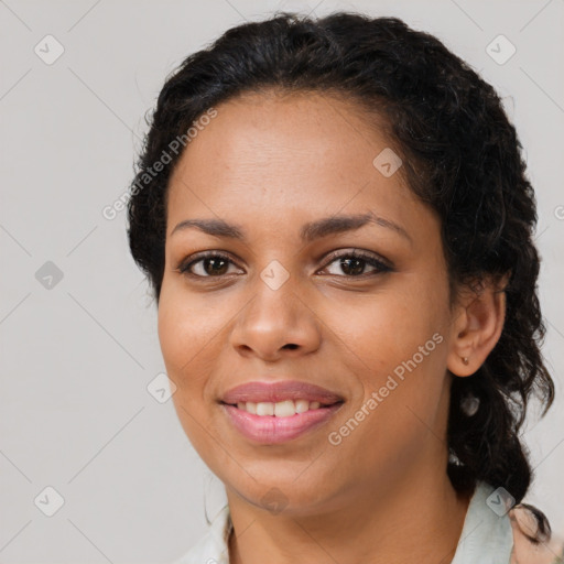 Joyful black young-adult female with long  brown hair and brown eyes