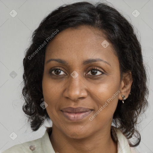 Joyful black adult female with medium  brown hair and brown eyes