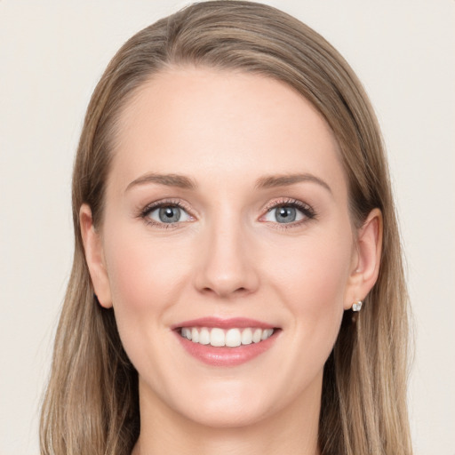 Joyful white young-adult female with long  brown hair and grey eyes