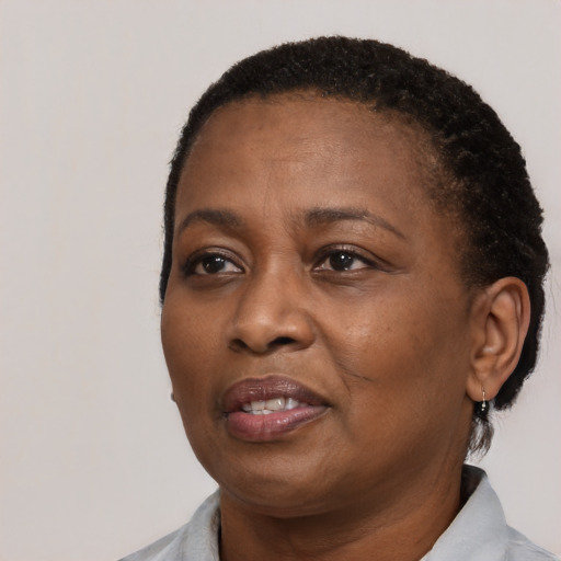 Joyful black adult female with short  black hair and brown eyes