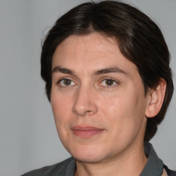 Joyful white adult female with medium  brown hair and brown eyes