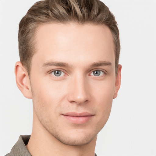 Joyful white young-adult male with short  brown hair and grey eyes